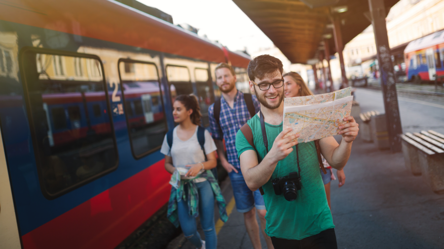 Grup de joves mirant un mapa a l'estació de tren